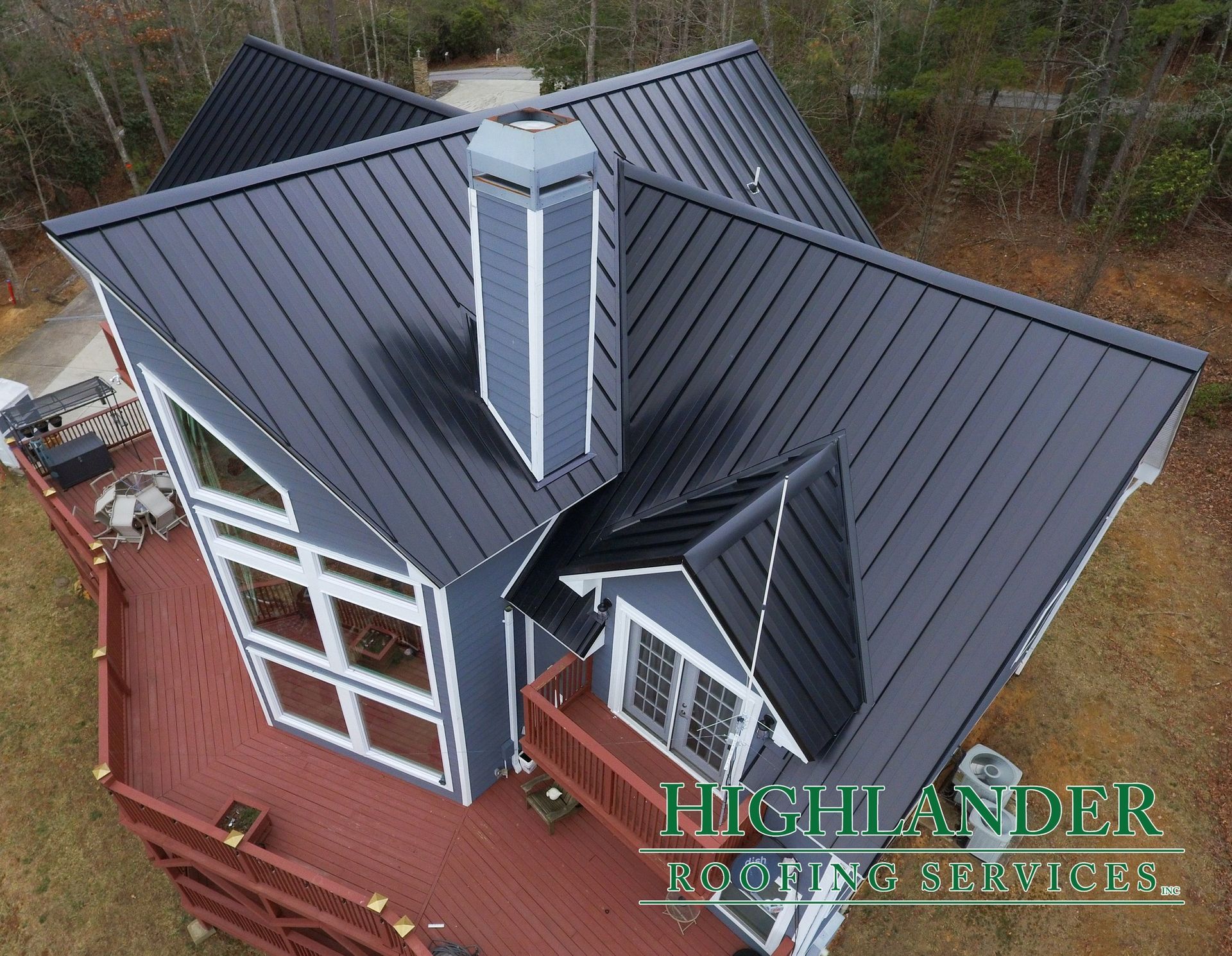 An aerial view of a house with a black metal roof