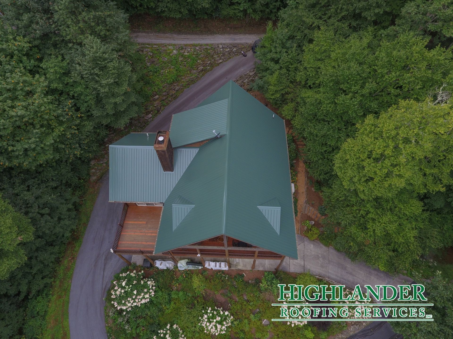 An aerial view of a house with a green roof
