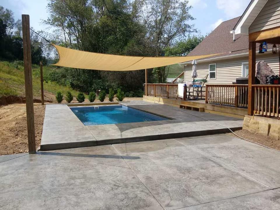 A patio with a swimming pool and a canopy over it