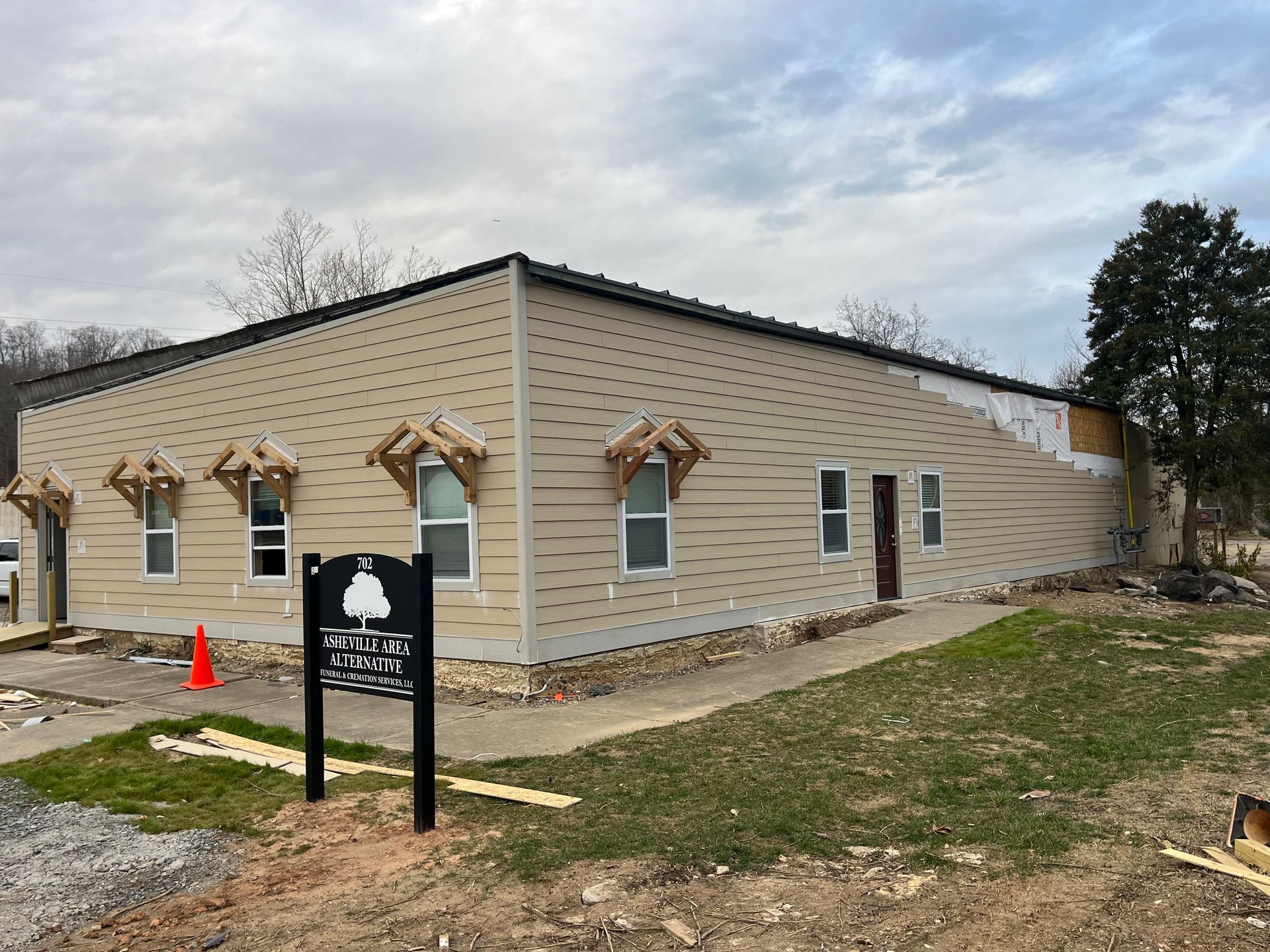 A building under construction with a sign in front of it.