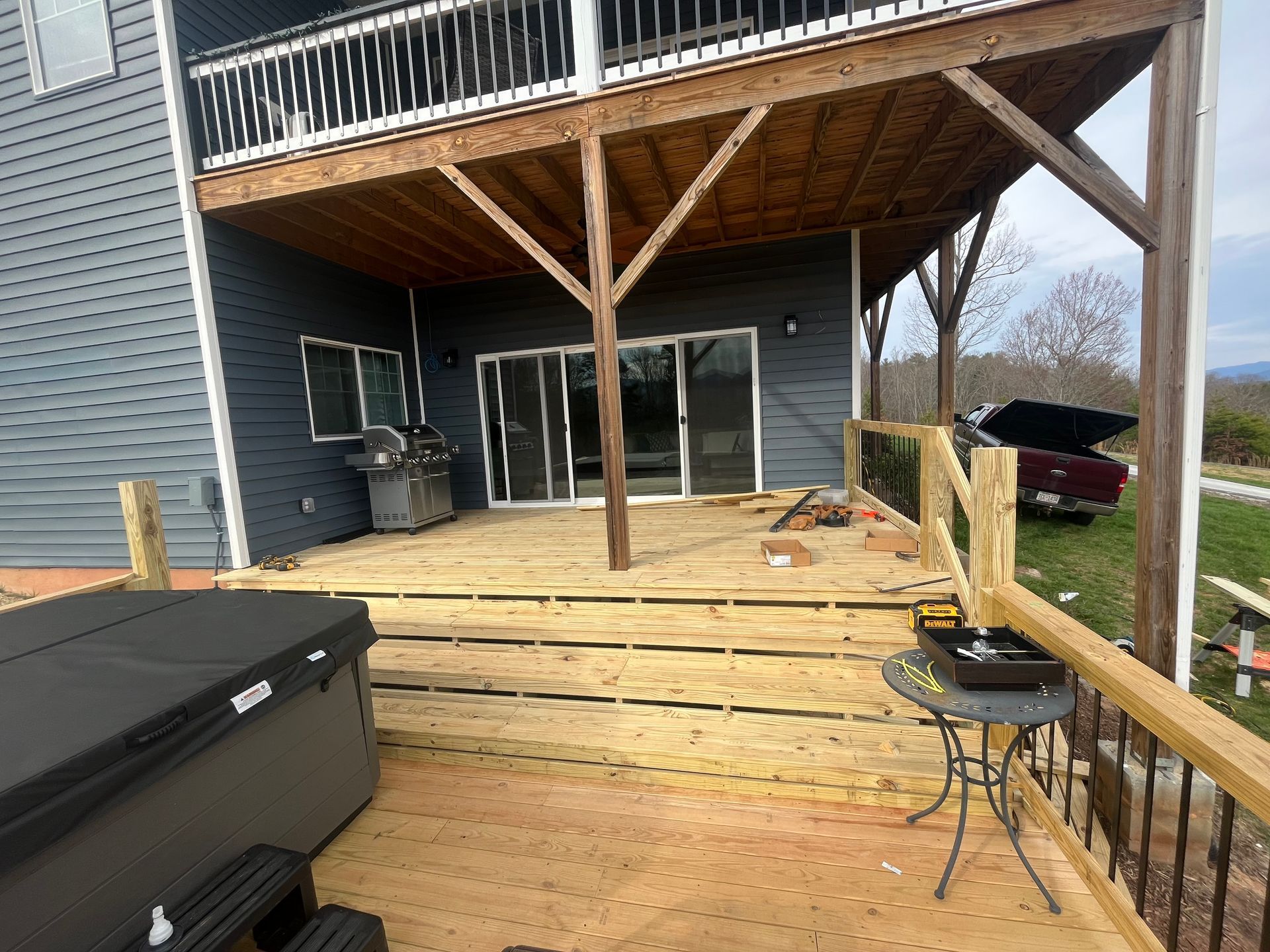 There is a hot tub on the deck of a house.