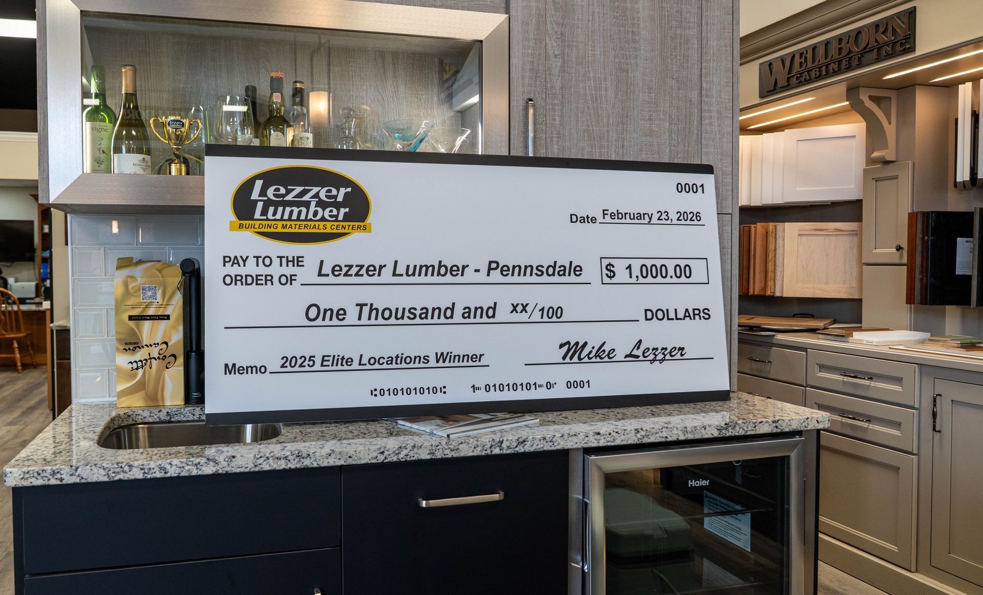 Luxury kitchen with a large check display on a marble island counter.