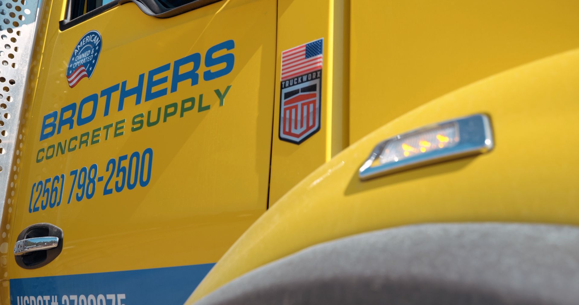 A yellow truck with brothers concrete supply written on the side