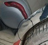 A close up of a tire on a car with a circle around it.