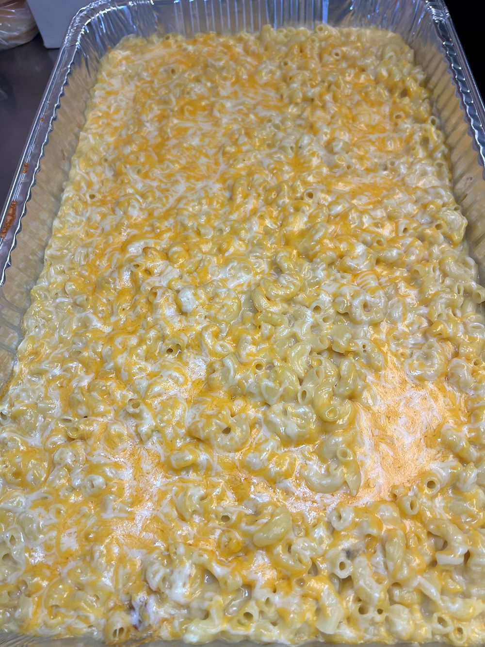A casserole dish filled with macaroni and cheese is sitting on a table.