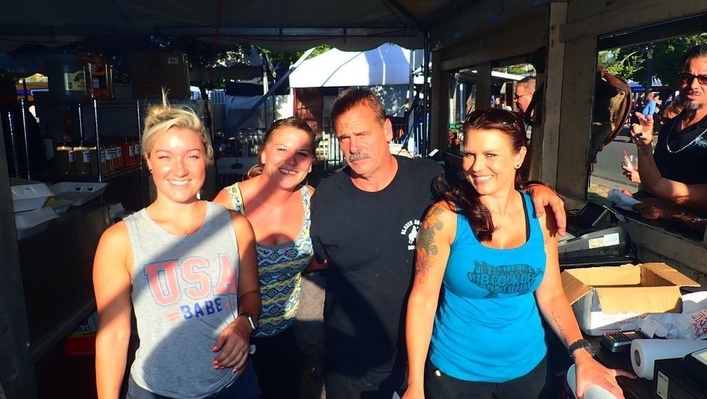 a group of people are posing for a picture in a tent