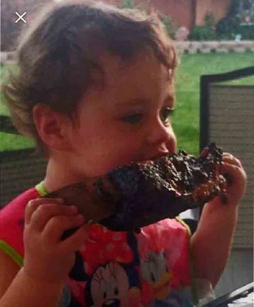 child eating barbecue