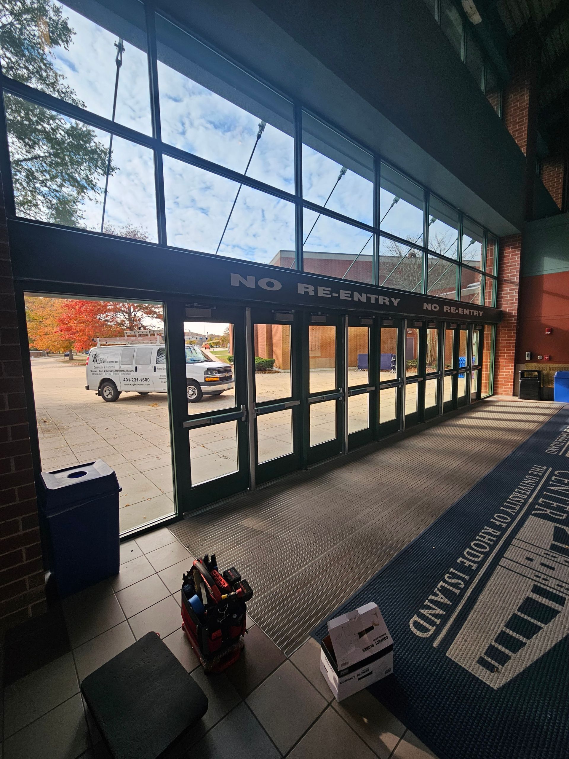 Exterior view of a building's entrance with glass doors, a
