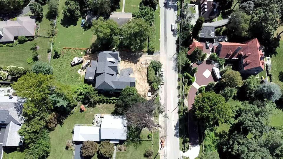 An aerial view of a residential area with houses and trees