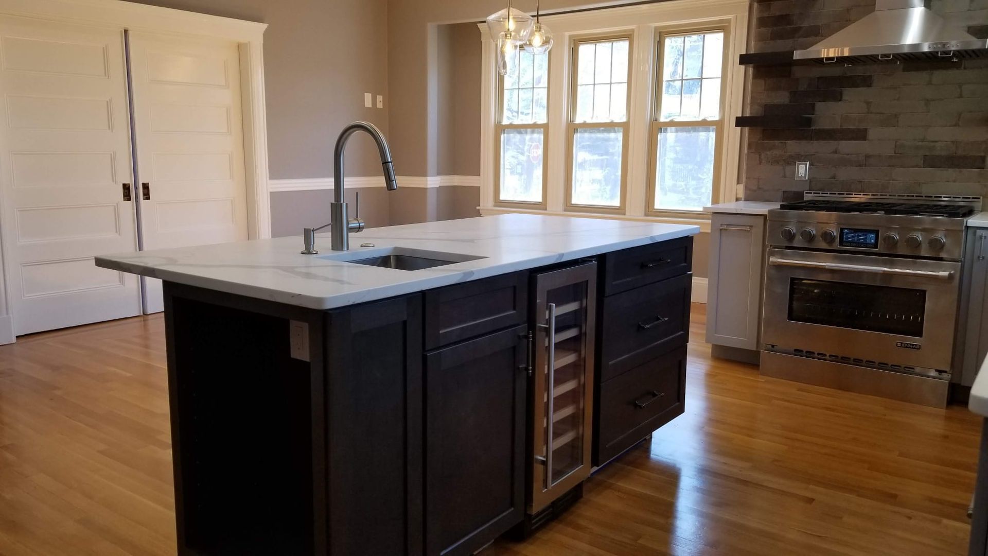 A kitchen with a large island and a sink