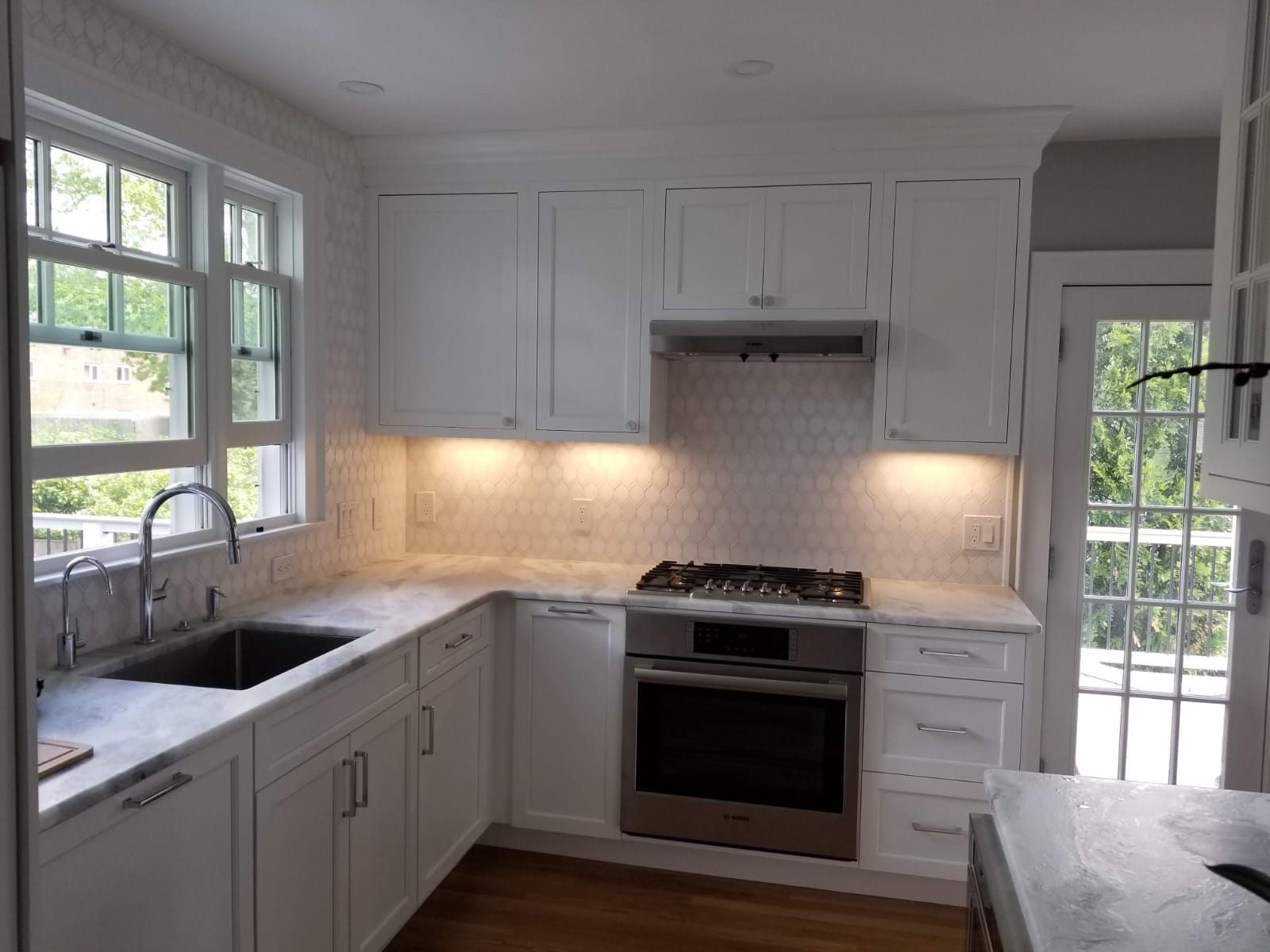 A kitchen with white cabinets and stainless steel appliances