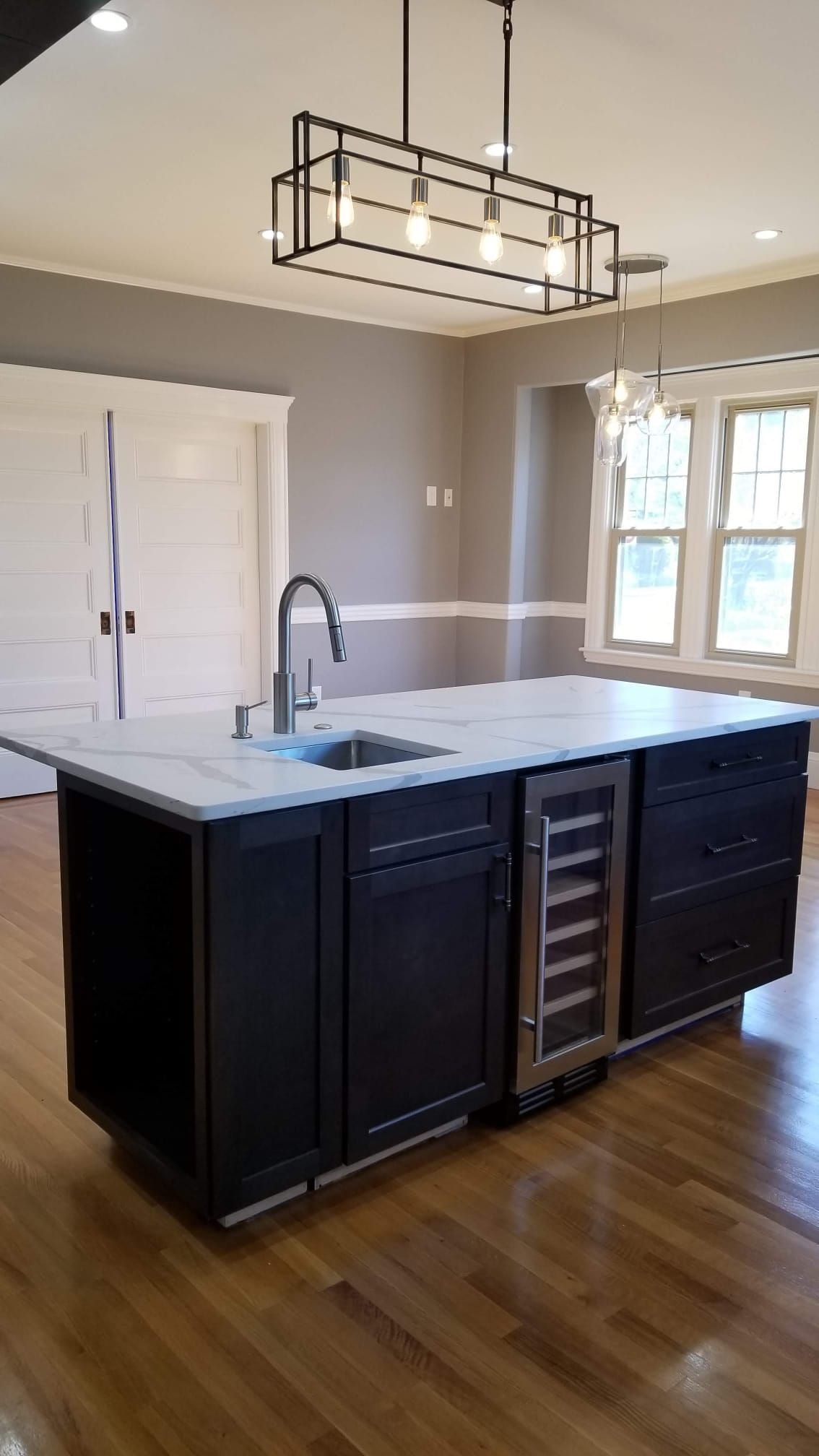 There is a large island in the middle of the kitchen.