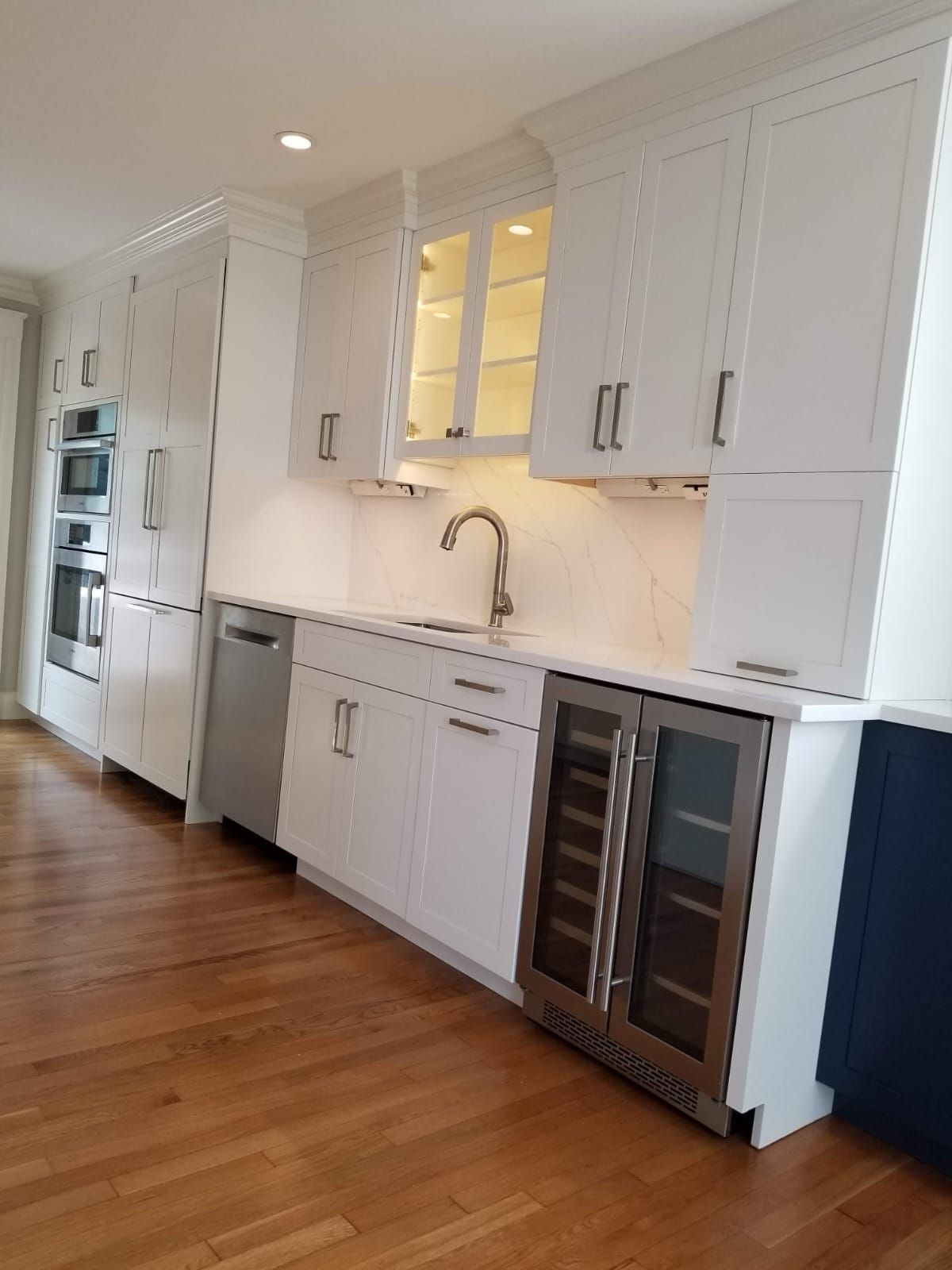 A kitchen with white cabinets and stainless steel appliances.