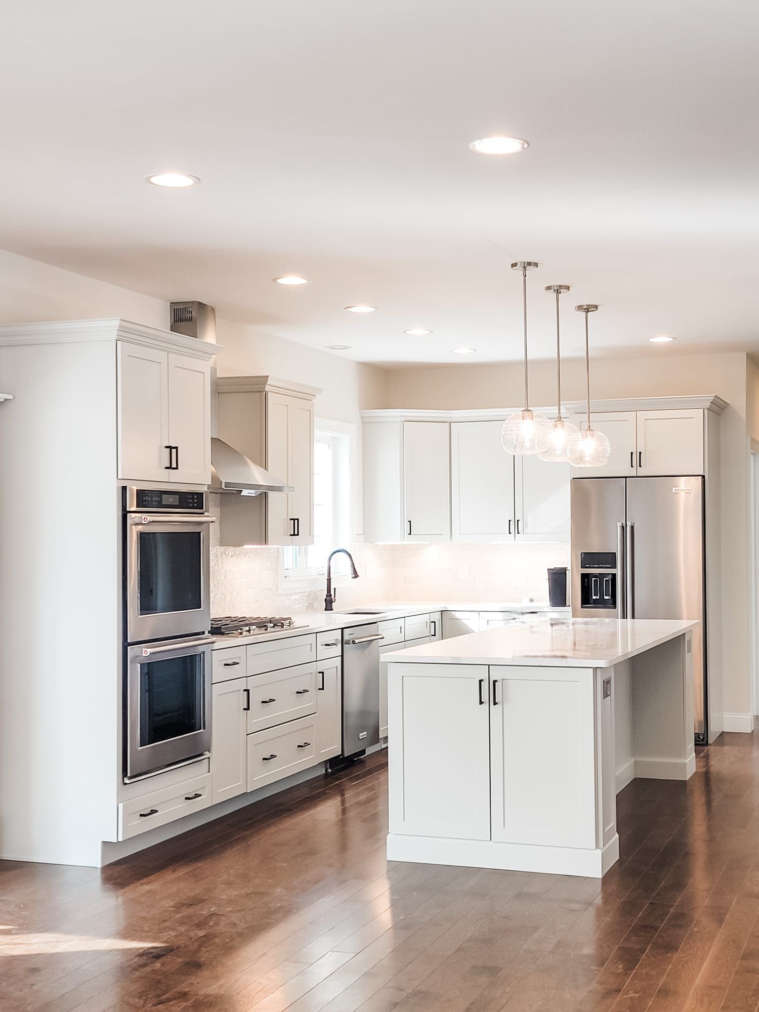 A kitchen with white cabinets and stainless steel appliances