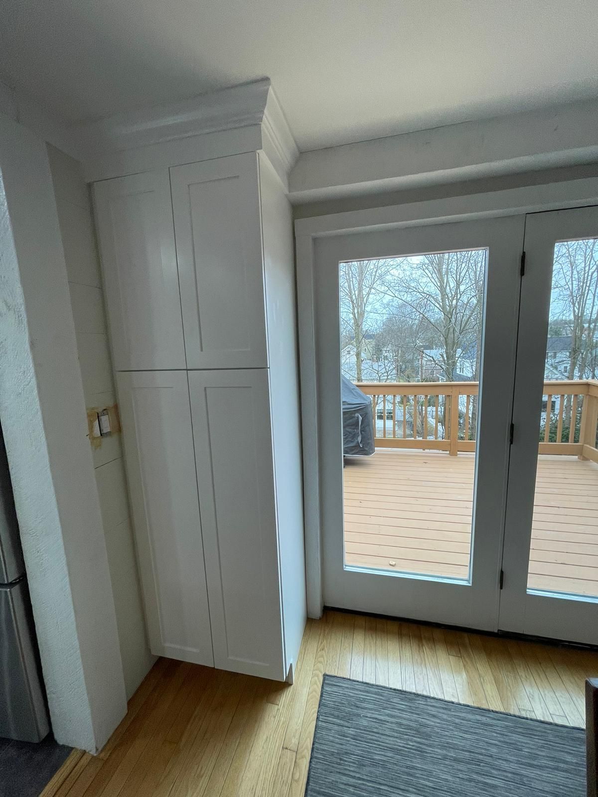 A room with a sliding glass door leading to a deck