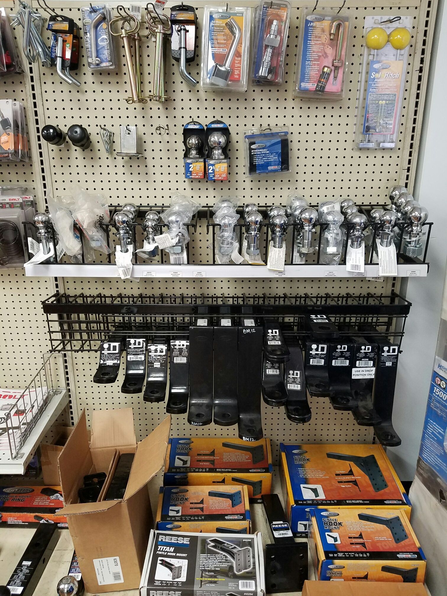 A store shelf filled with lots of tools and boxes.