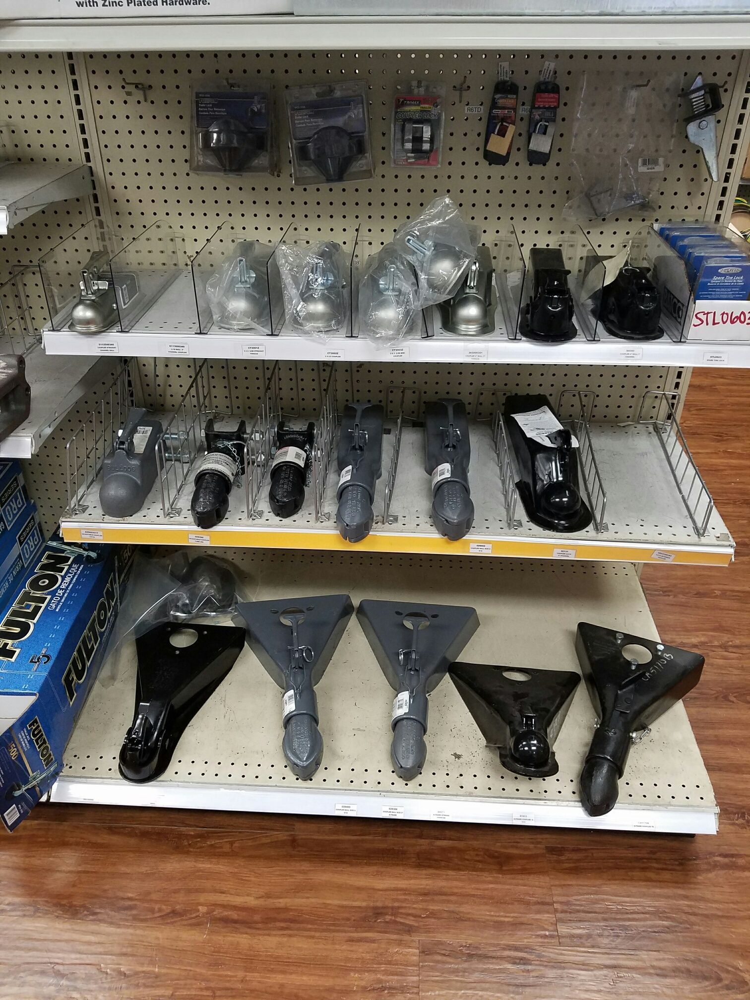 A store shelf filled with a variety of trailer parts.