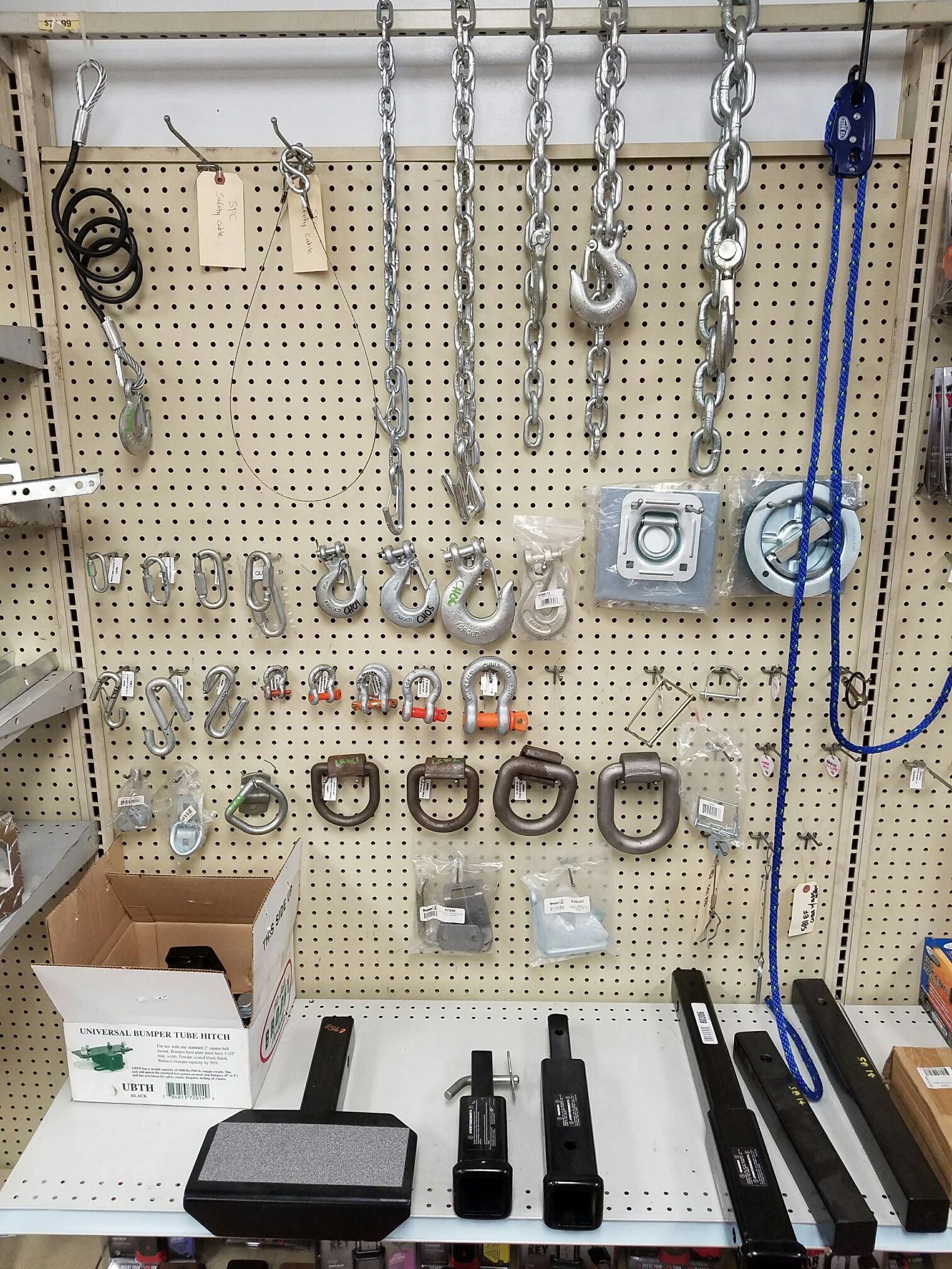 There are many different types of chains hanging on the wall.