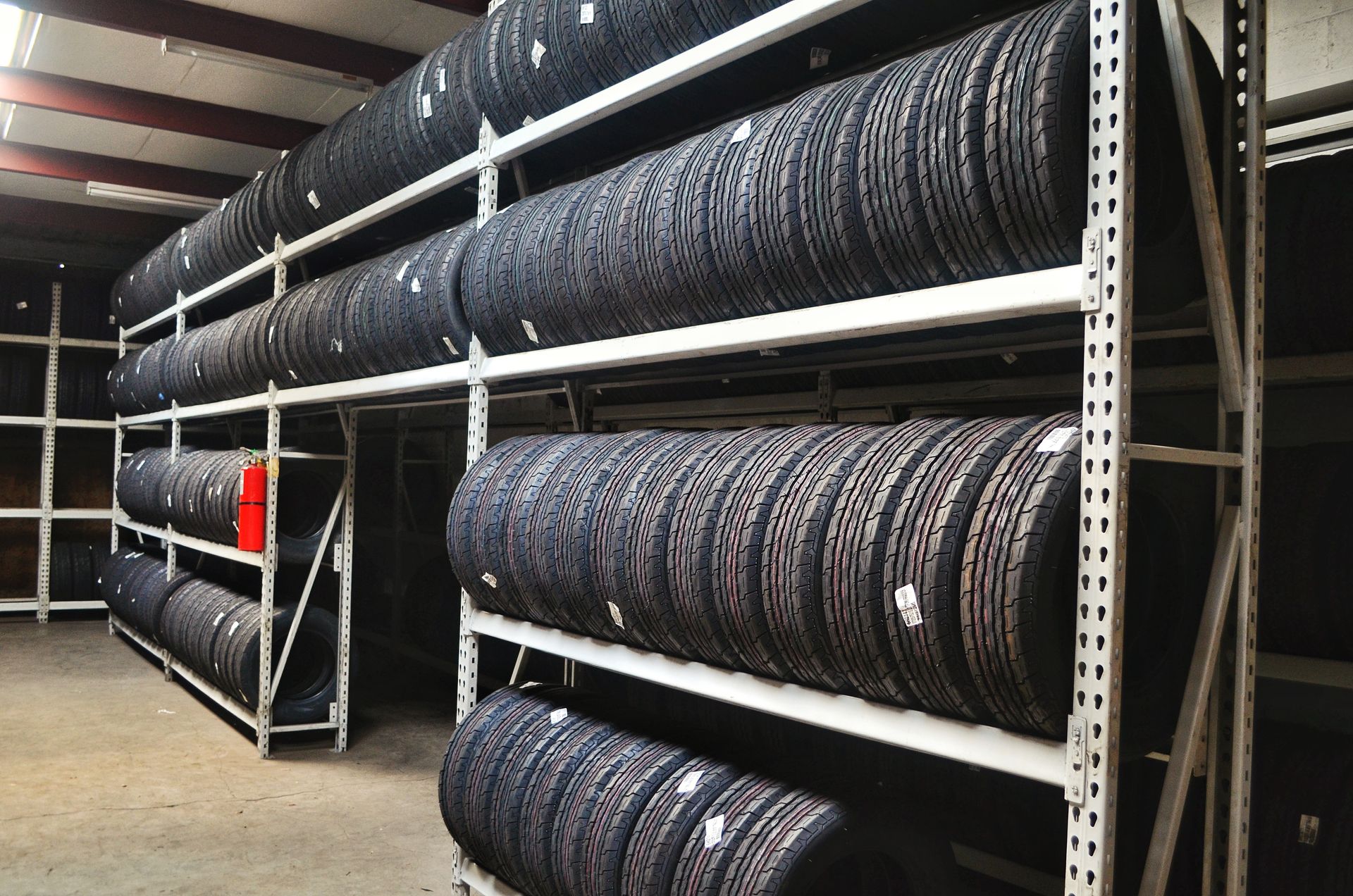 A warehouse filled with lots of tires on shelves