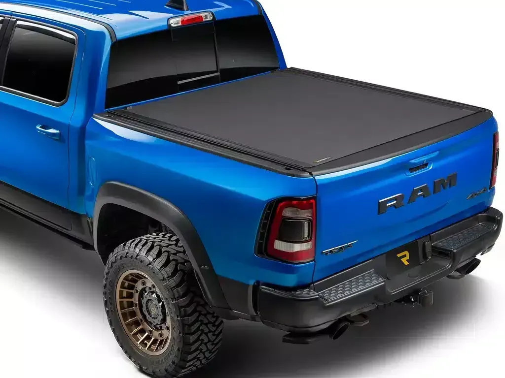 Blue pickup truck with black tonneau cover on tailgate.