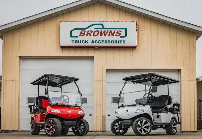 Two custom golf carts parked outside