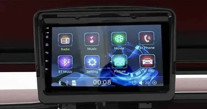 Car's touch screen with icons for radio, music, video, phone, car settings and more, black frame, digital clock display.