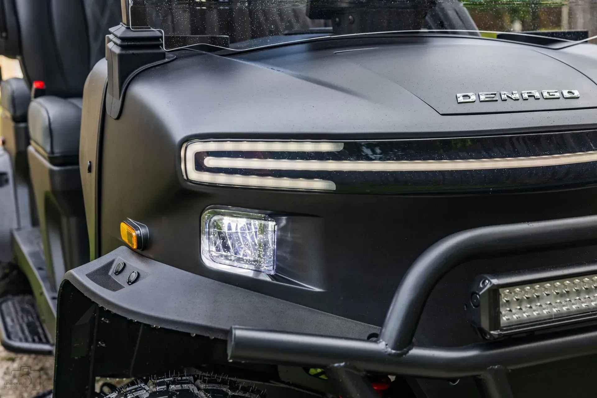 Black golf cart with LED headlights and front bumper bar.