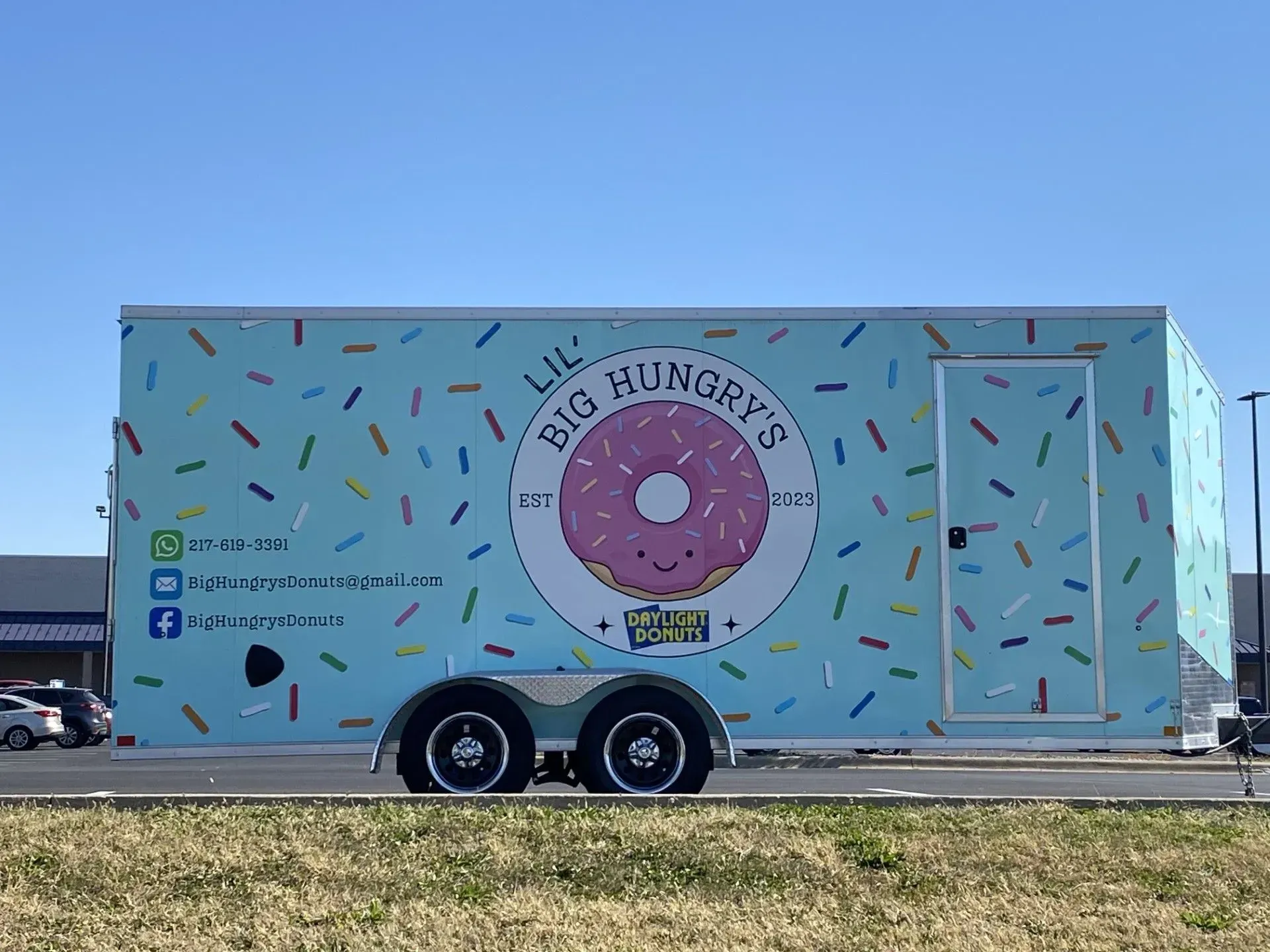 A light blue donut food trailer,
