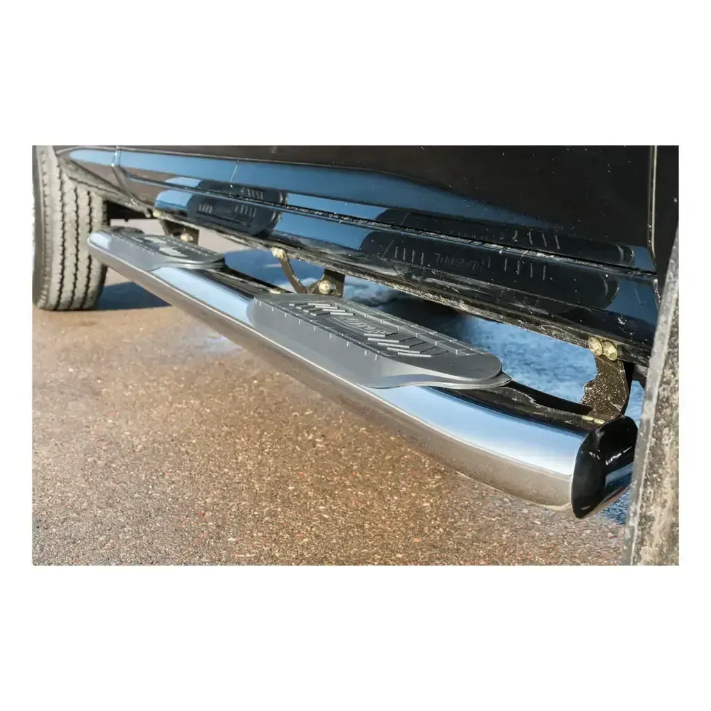 Chrome running board installed on a black truck.