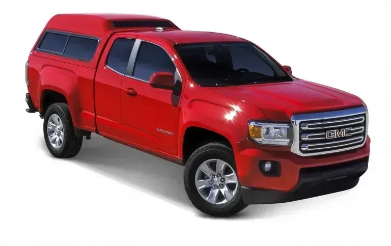 Red GMC Canyon pickup truck with a camper shell.