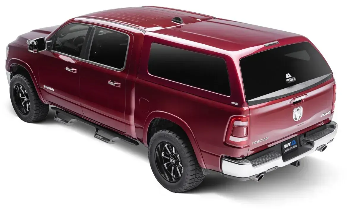 Red pickup truck with a matching camper shell, viewed from a high angle.