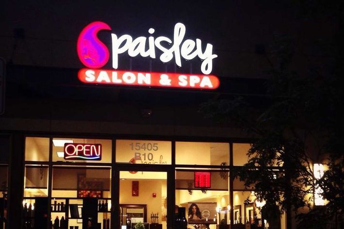 A spaisley salon and spa is lit up at night