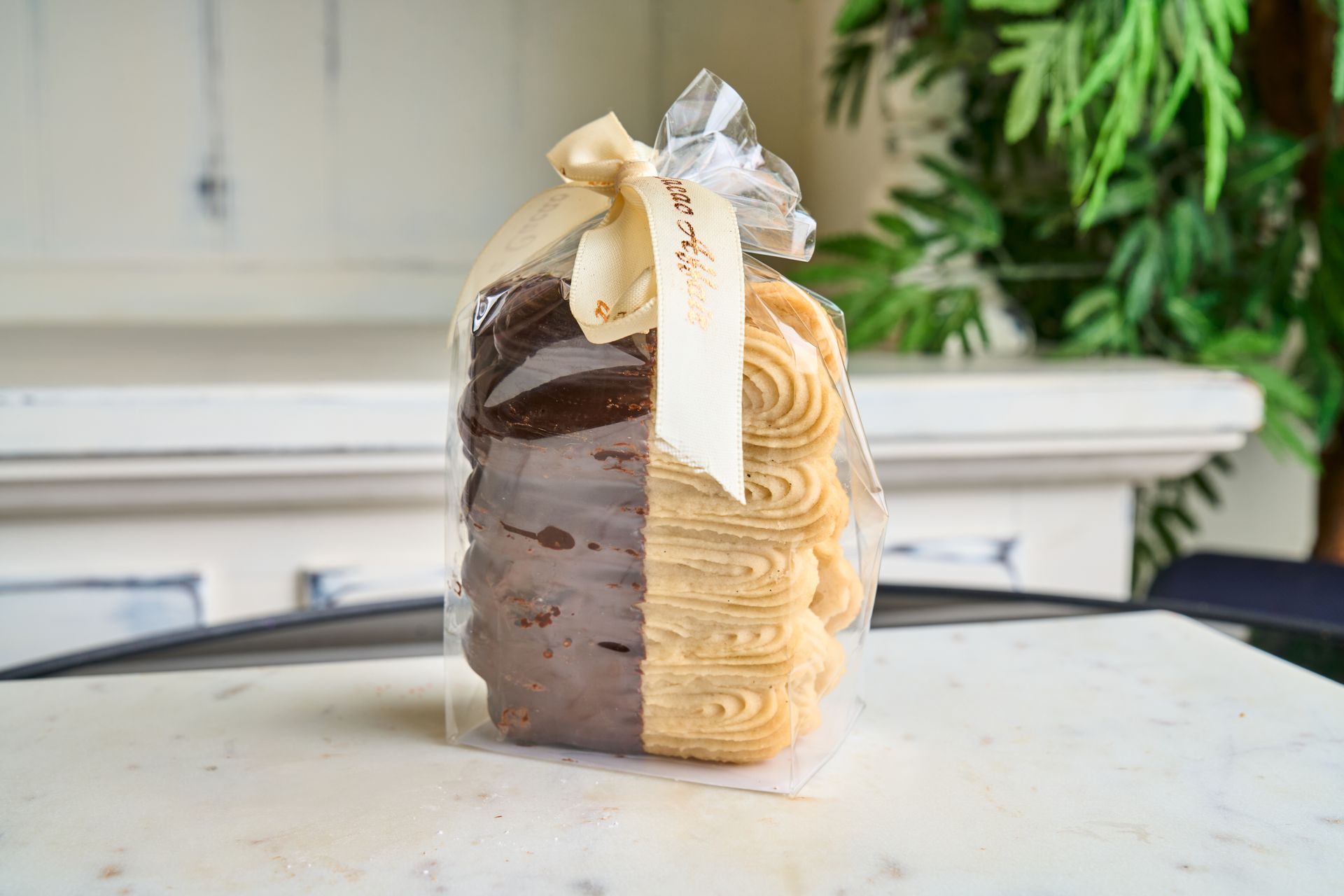 Pack of cookies, half chocolate, half butter, tied with a cream ribbon.