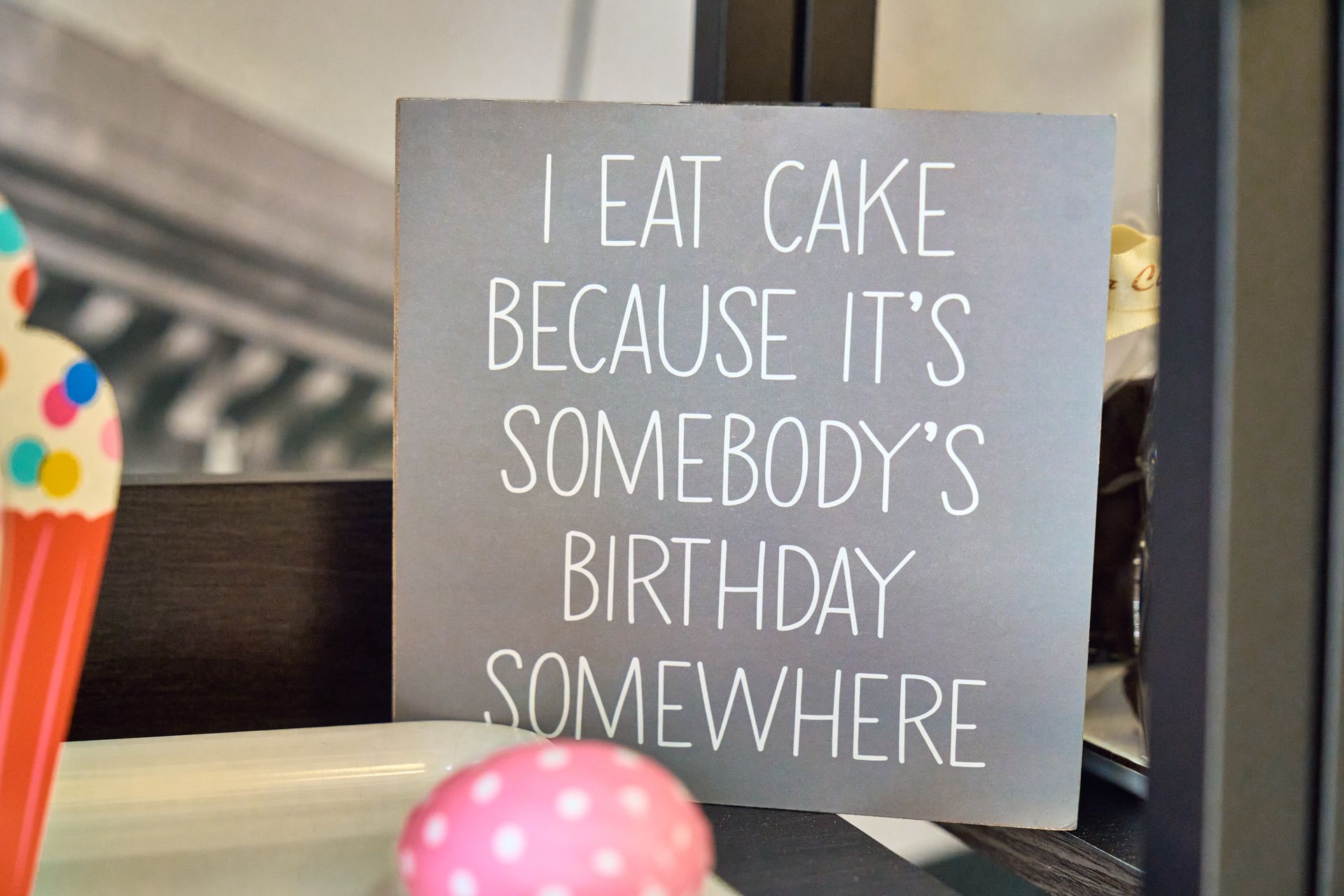 Gray sign with white text: 