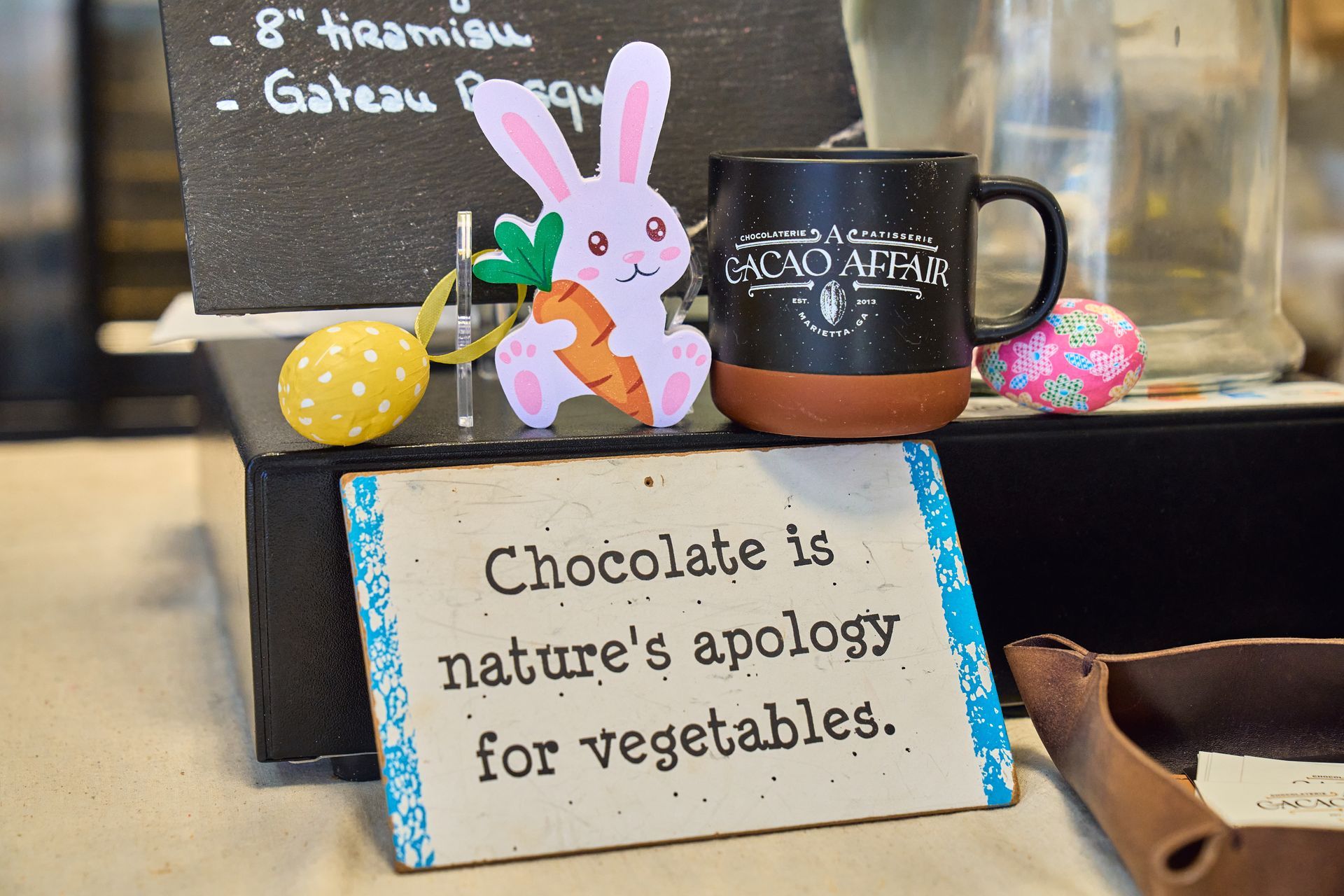 Easter display with a bunny, eggs, and a sign that reads, 
