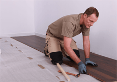 Man piling up the wooden floor