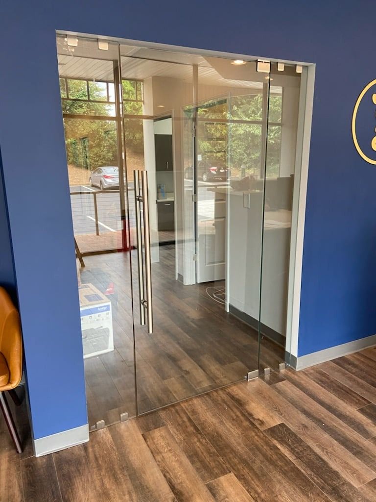 A room with a blue wall and a glass door.