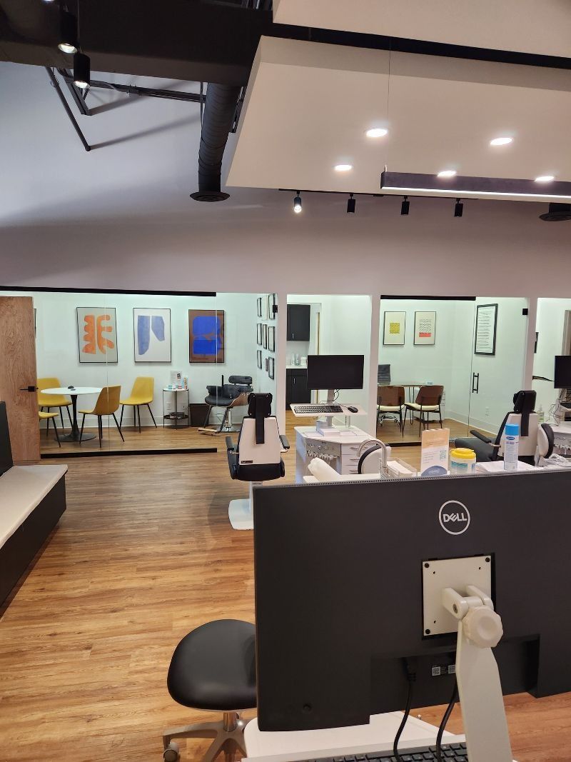 A dell computer monitor sits on a desk in an office