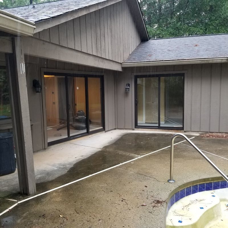 A house with a swimming pool in front of it