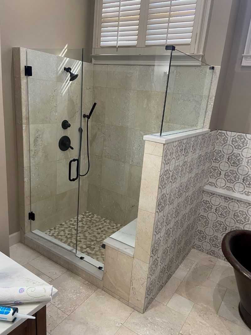 A bathroom with a walk in shower and a bathtub.