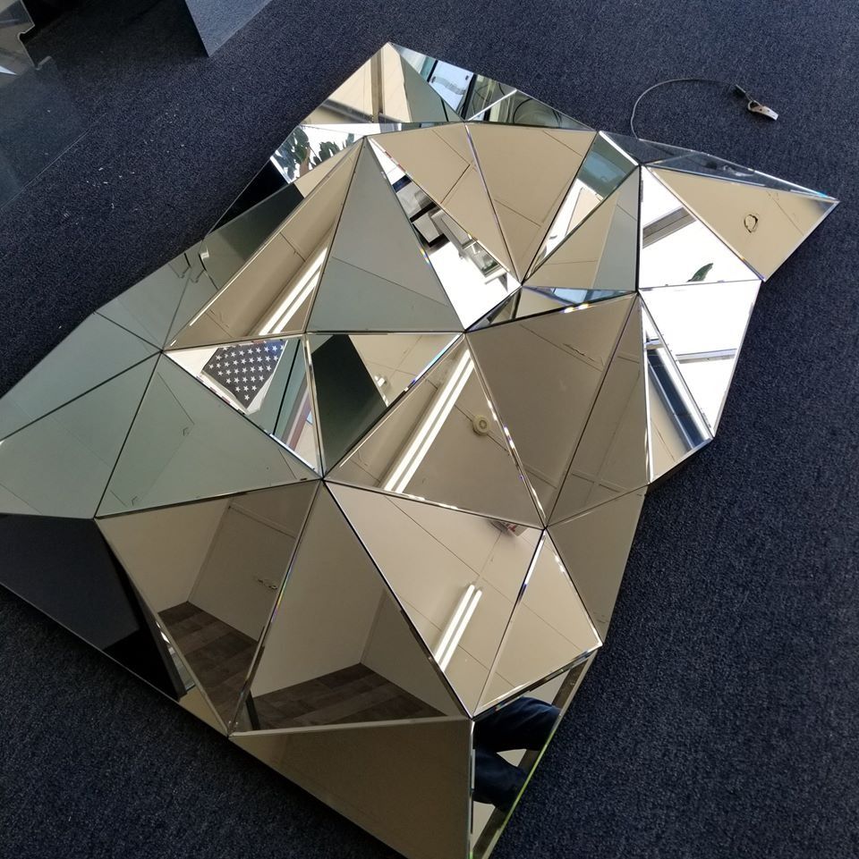 A large mirror sitting on top of a carpeted floor
