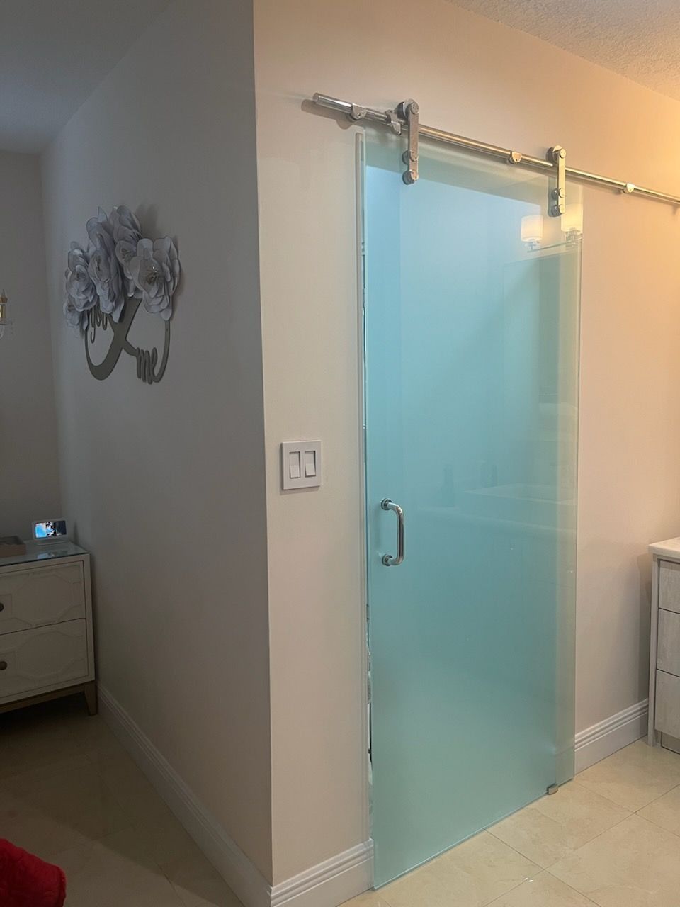 There is a sliding glass door in the corner of the room.