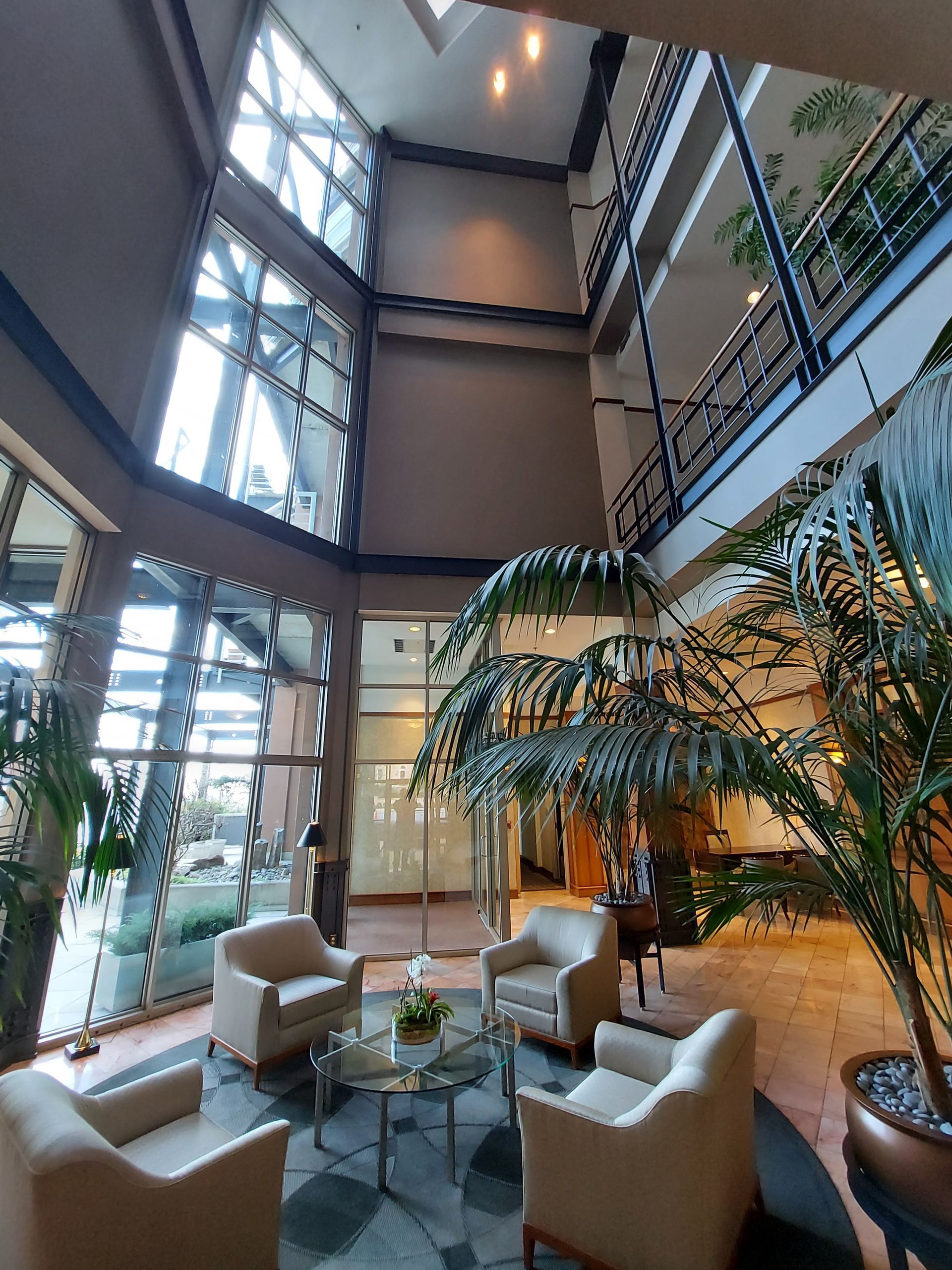 A large lobby with lots of furniture and plants