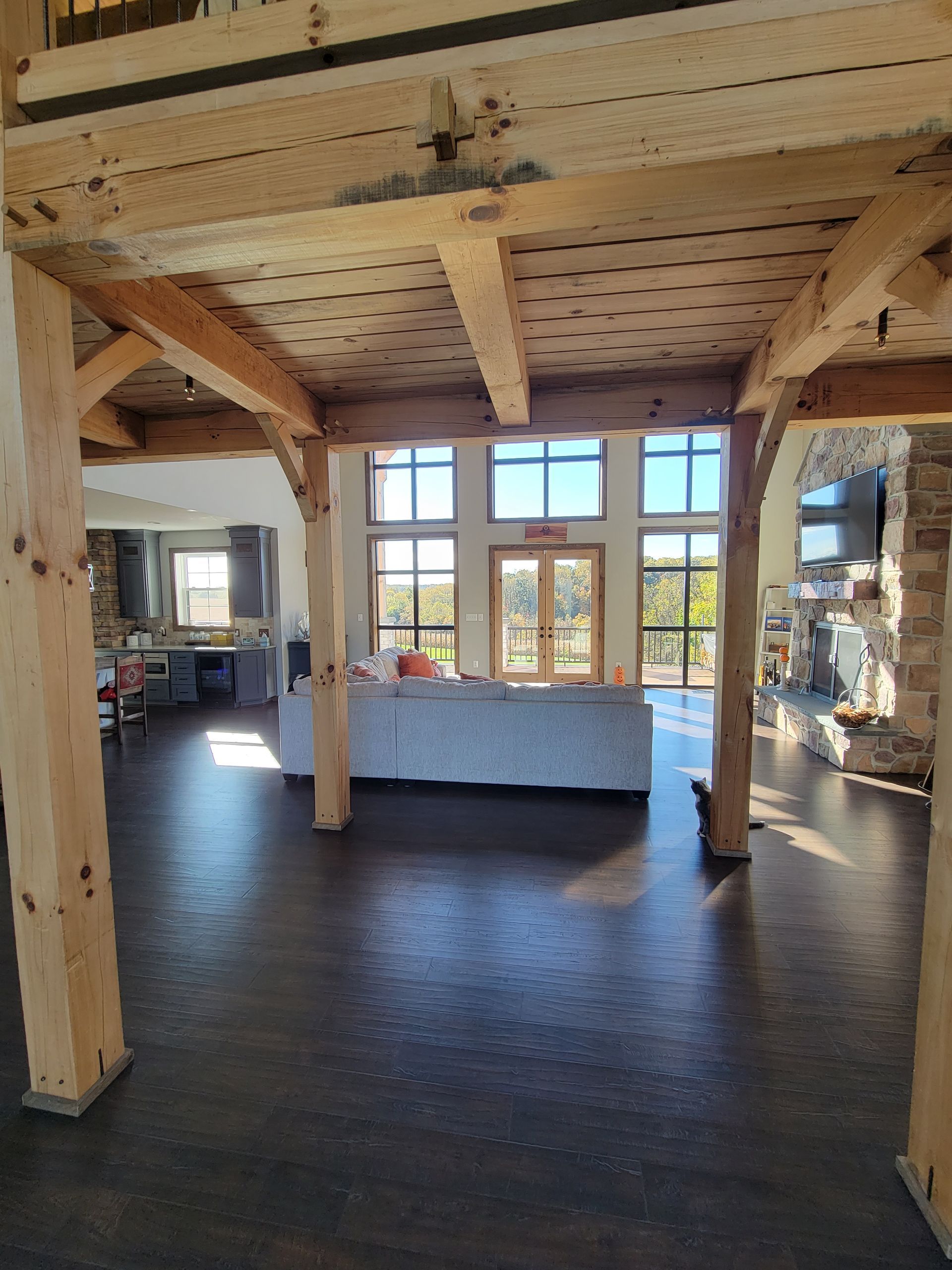A large room with a lot of windows and wooden beams