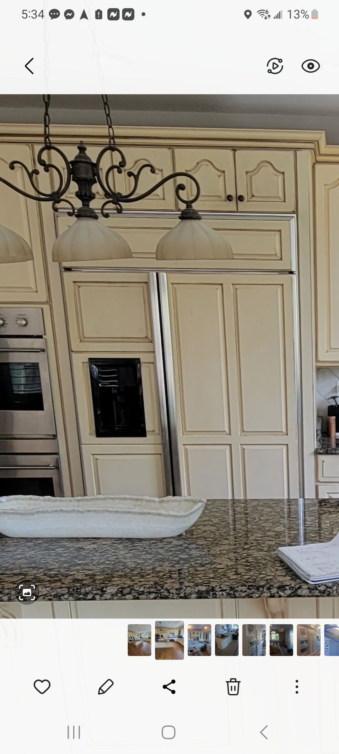 A kitchen with white cabinets and granite counter tops.