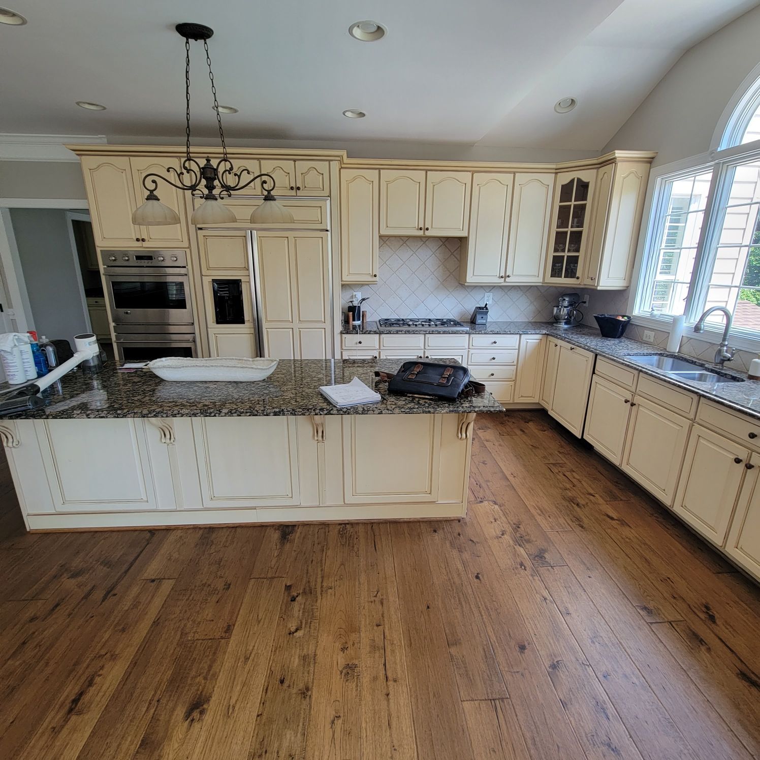 A kitchen with white cabinets and granite counter tops
