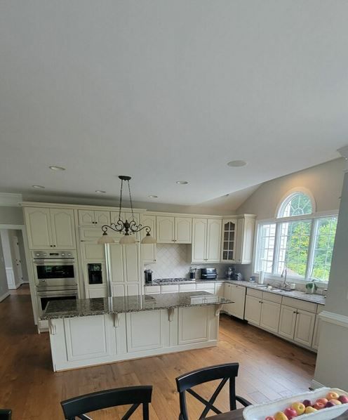 A kitchen with white cabinets and granite counter tops