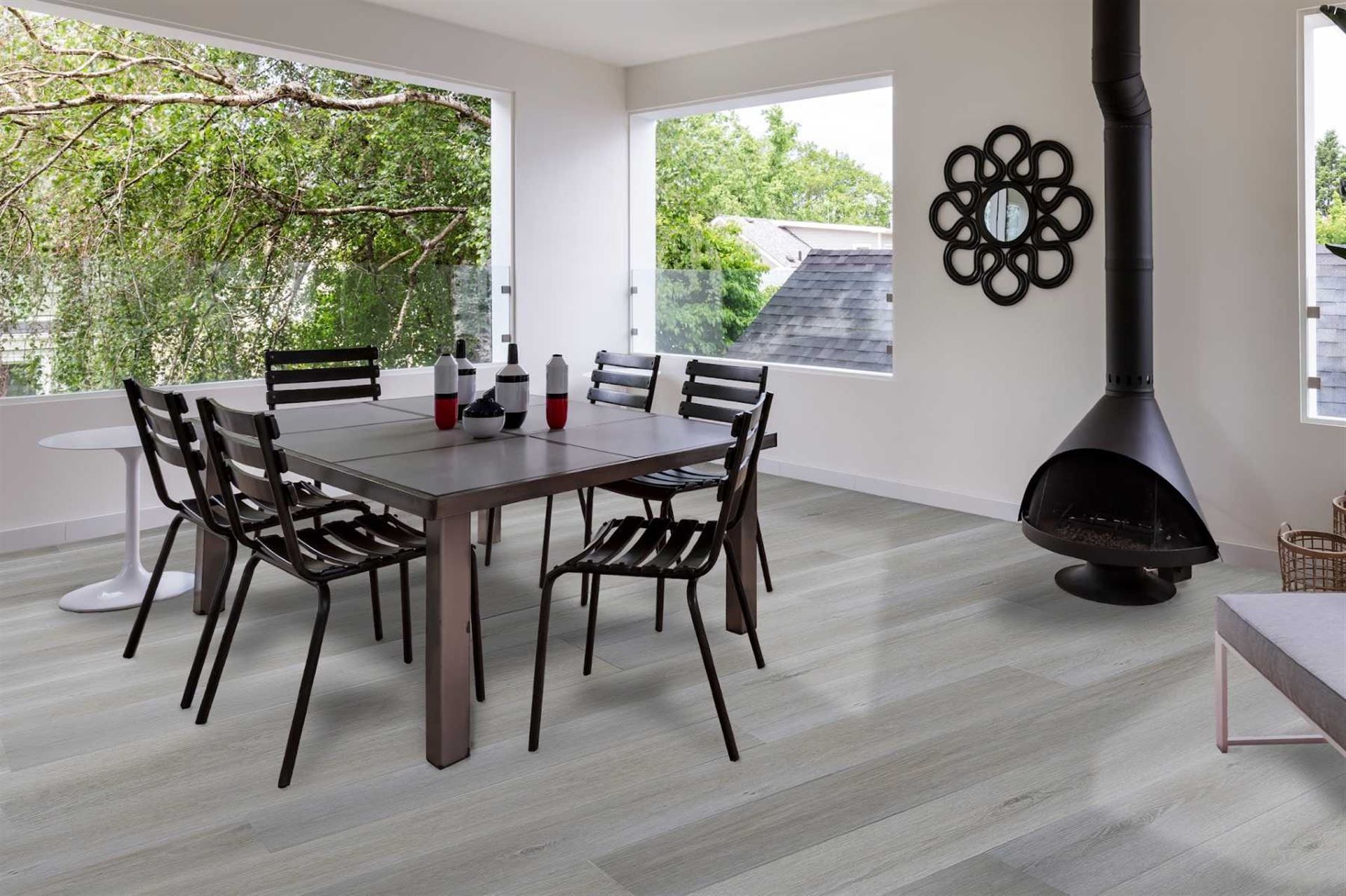 A dining room with a table and chairs and a fireplace.