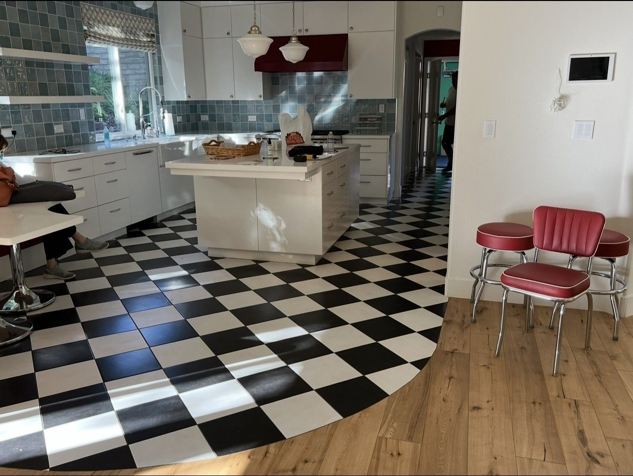 A kitchen with a black and white checkered floor