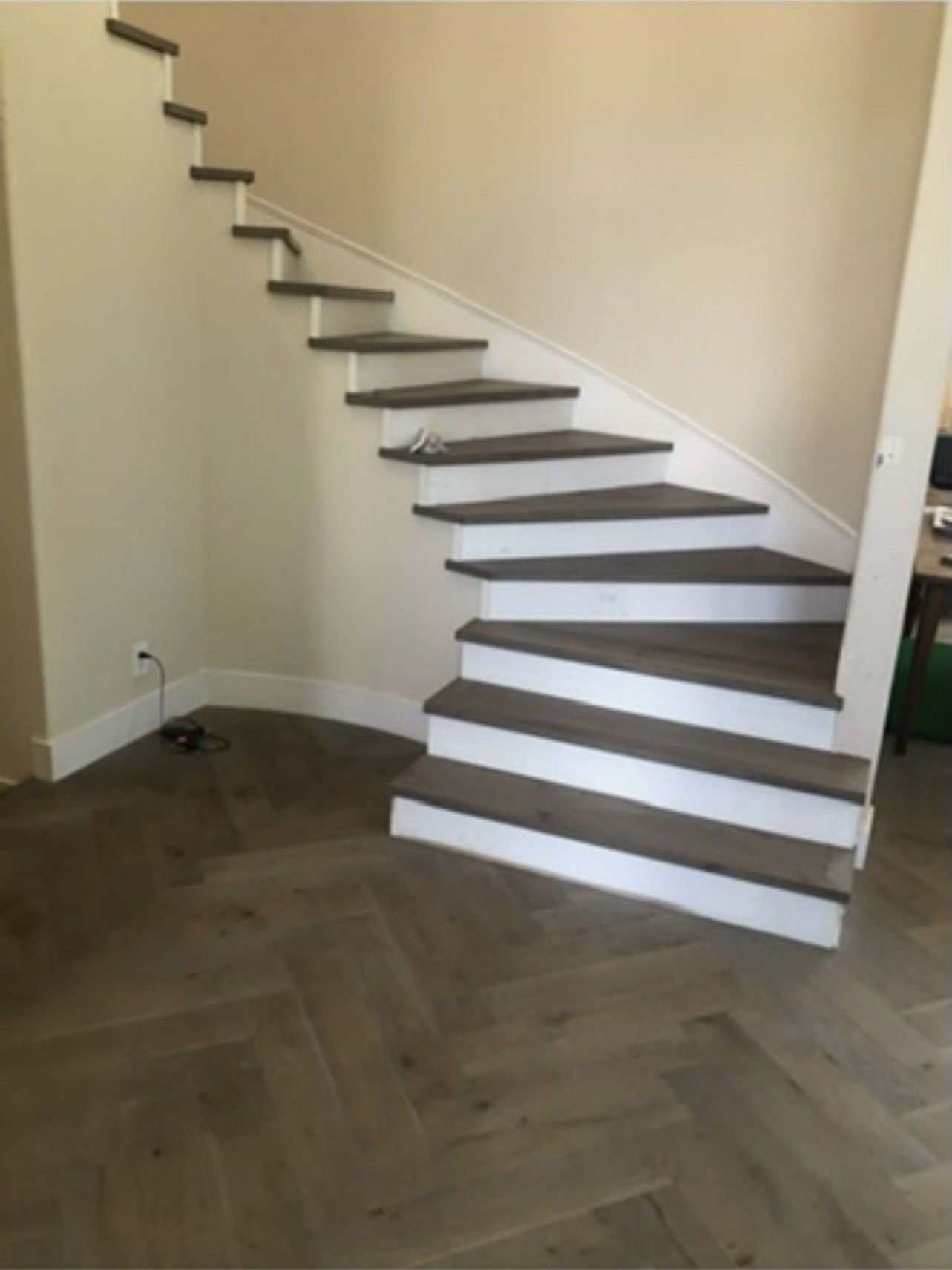 A spiral staircase in a room with a wooden floor